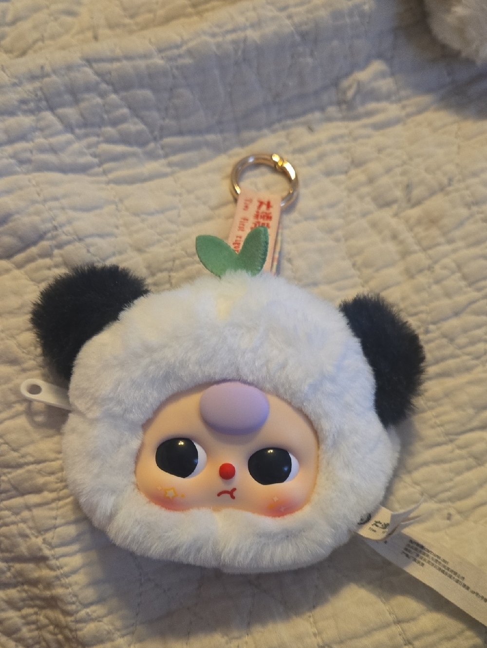 Baby Three plush storage pouch features a panda character